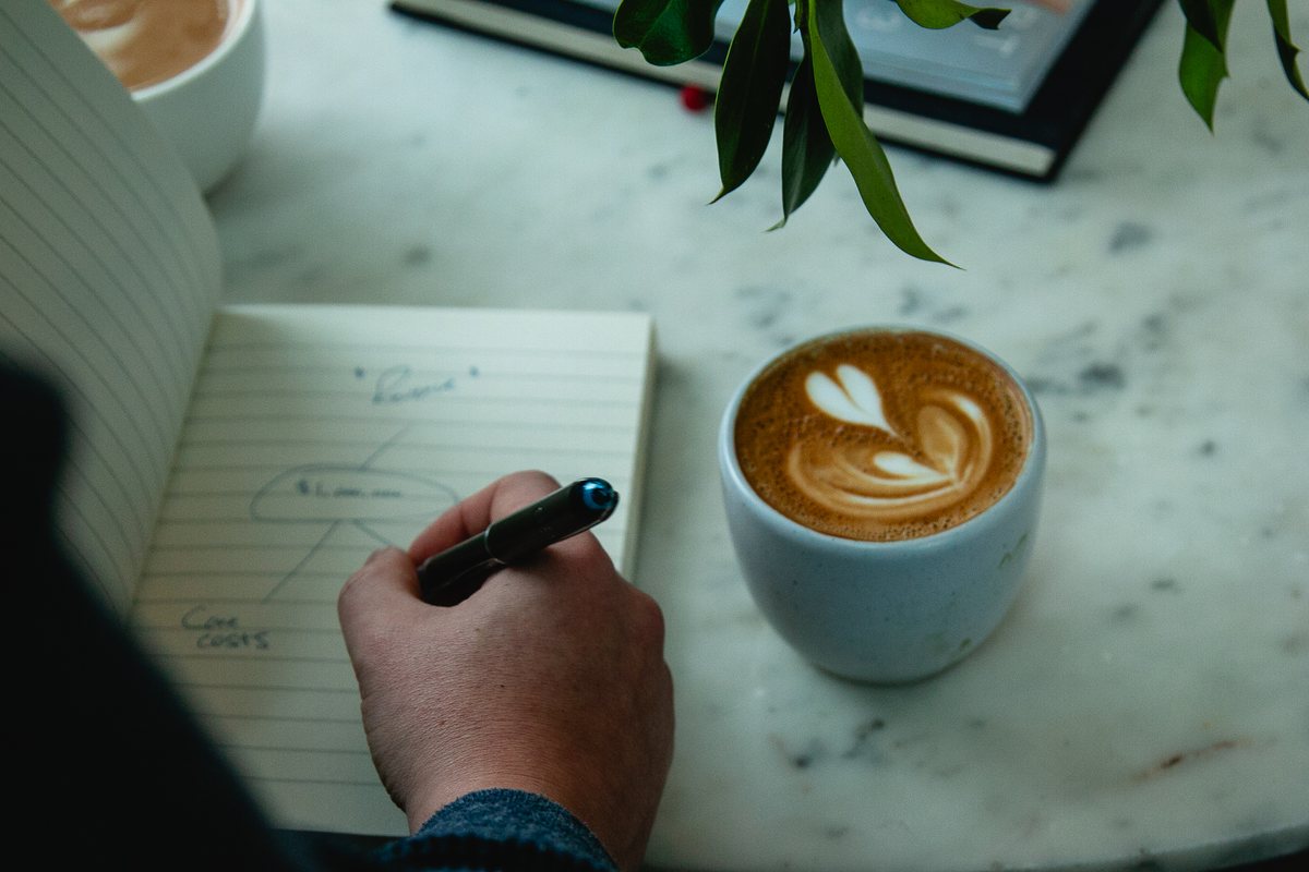 Planning over coffee with a hand-drawn revenue diagram